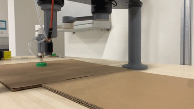 Five-bar SCARA robot picking and moving a small green object with a vacuum end effector